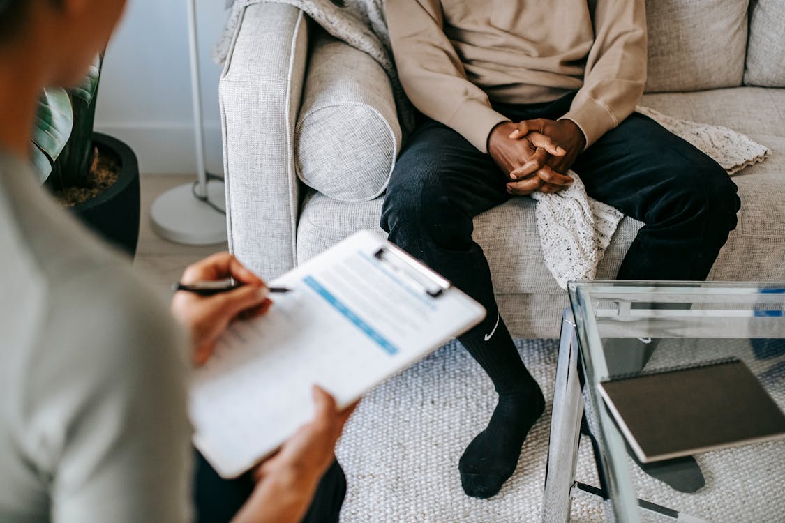 Two people sitting in a therapy office image