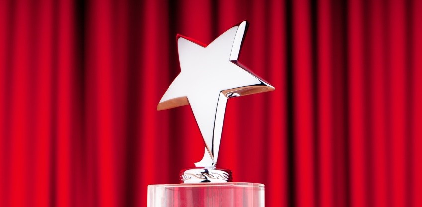 Star-shaped trophy with a red curtain backdrop